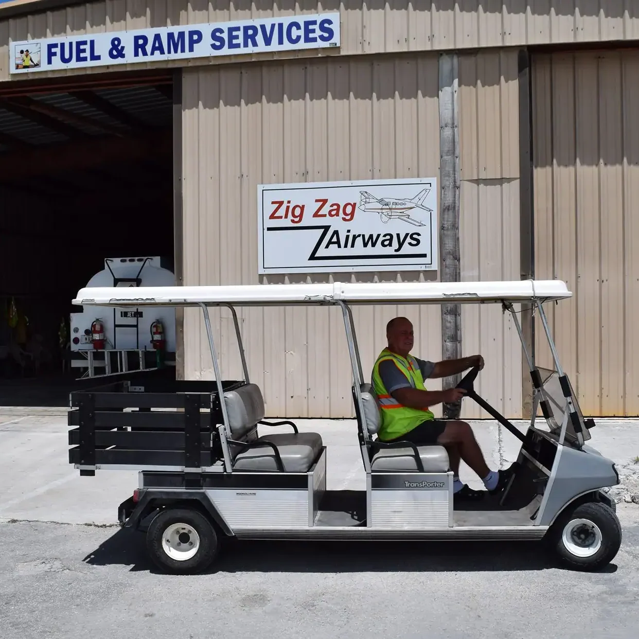 Man driving electric shuttle cart at airport